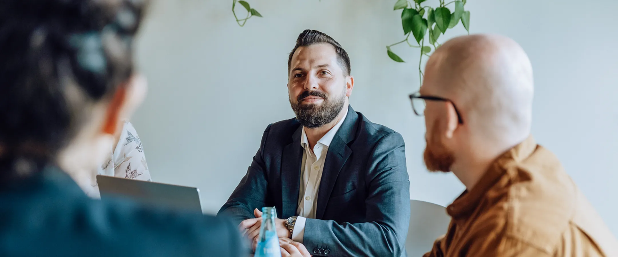 three people talking at a table