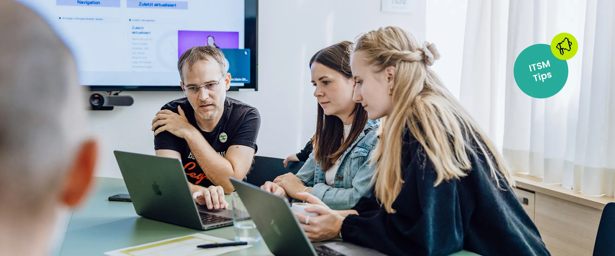 IT team collaborating around a service ticket dashboard