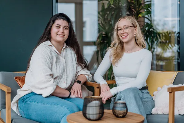 two colleagues smiling at the camera