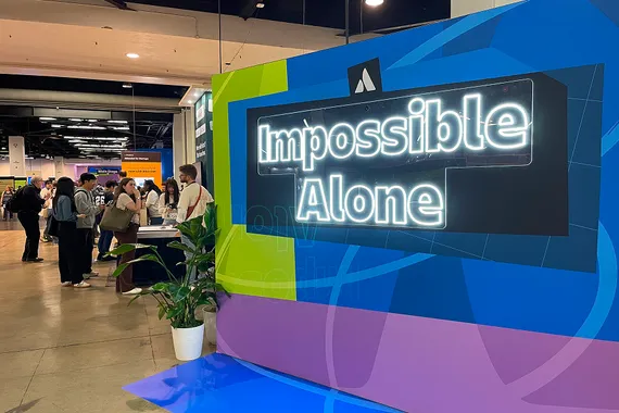 Atlassian Team '26 conference floor with Impossible Alone signage