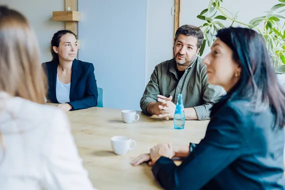 four people sitting at a table