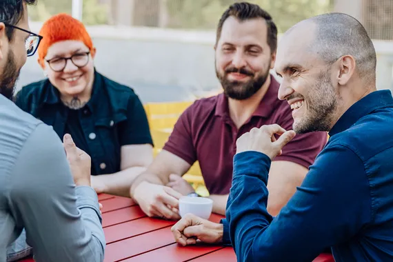 people sitting together at a table chatting