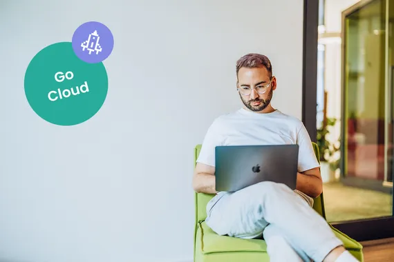 IT employee reviewing a cloud migration plan on a laptop