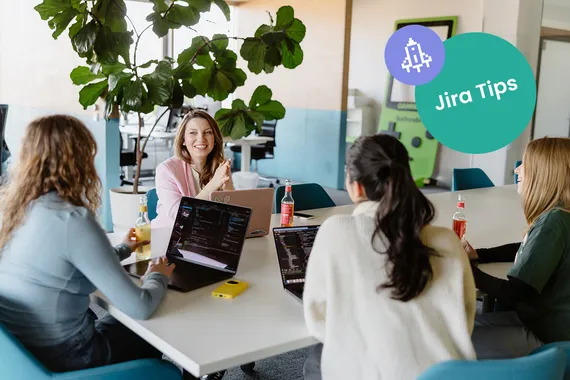 four people smiling and co-working with laptops