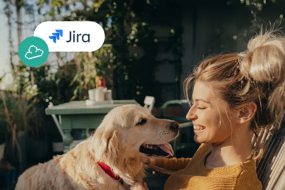 a woman smiling at a dog on her lap