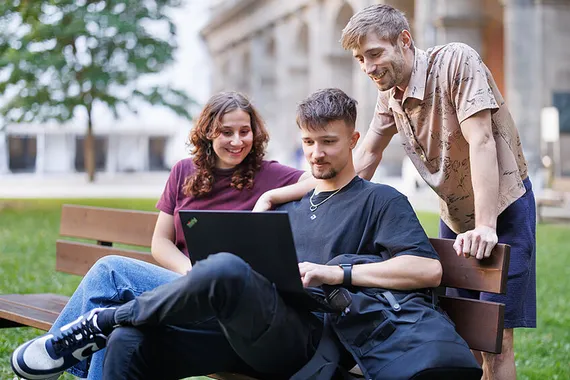 three students looking at a computer screen