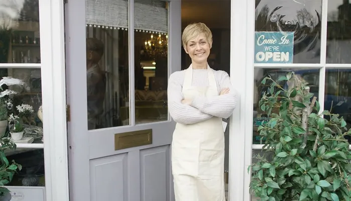 A woman standing outside of a shop